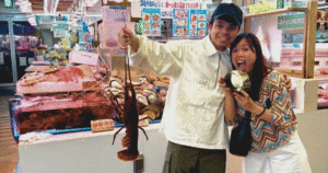 holding giant lobster at makishi public market